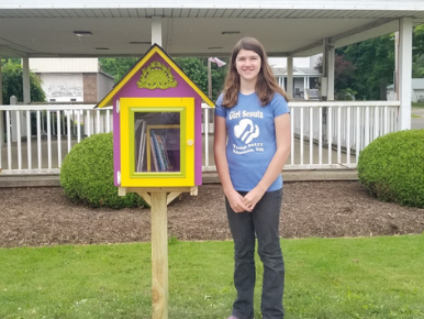 Little Free library box at park with girl scout representative